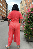 Britta jumpsuit Ranka - Orange and white striped jumpsuit in organic cotton